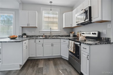 Kitchen featuring stainless steel appliances, a si