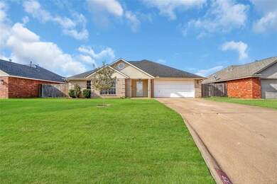 Ranch-style home featuring a front yard and a gara