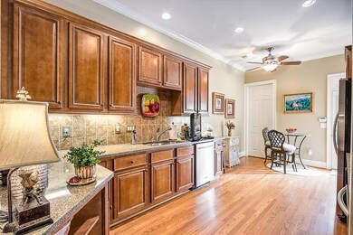 This efficient kitchen, featuring granite, hardwood floors & maple cabinets, will make preparing meals a joy.