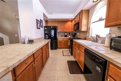 Gourmet kitchen features extended cabinets, tile,