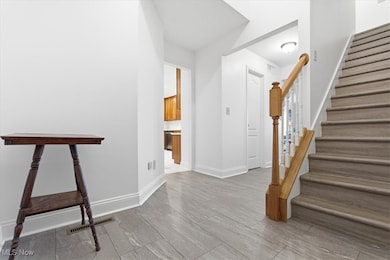 Stairs with baseboards and wood finished floors