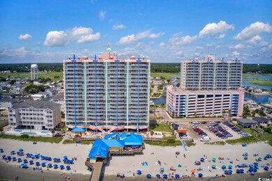 Drone / aerial view of a nearby body of water and apartment complex