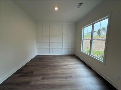 Office/study with accent wall, and ornamental molding