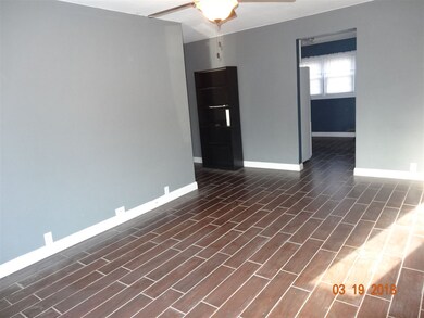 LIVING ROOM WITH WOOD LOOKING TILE