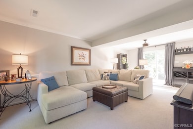 Living area with carpet floors and ornamental mold