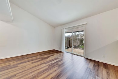 Spare room featuring lofted ceiling, wood finishe
