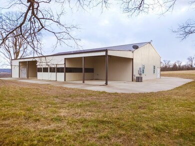 Back of shop house.  Covered bays. Enclosed patio area. Storage on end.