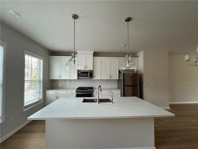 Kitchen featuring decorative backsplash, stainless
