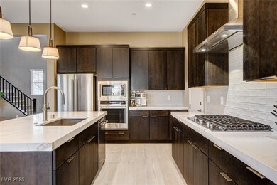 Kitchen featuring wall chimney exhaust hood, dark