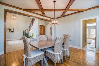 Beautiful wood beams grace the ceiling in the formal dining room.  Butler's pantry to the right.