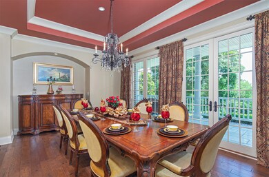Formal Dining Room with furniture niche, trey ceiling and 2 sets of French doors to front balcony