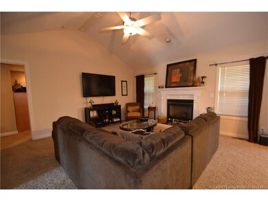 Living room has vaulted ceiling, fan, gas fireplac