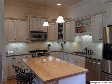 Lots of pretty cabinets with granite countertops.