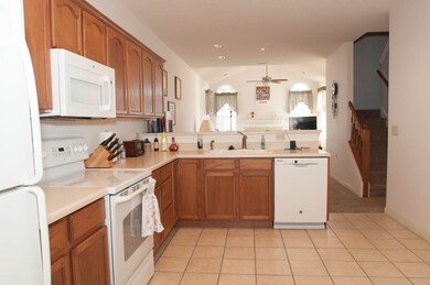 Kitchen with lofted ceiling, sink, light tile patt
