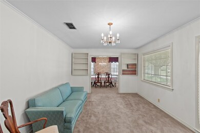 Sitting room featuring light carpet, an inviting c