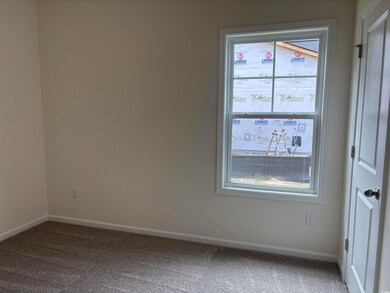 Carpeted spare room with baseboards