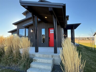 Entrance to property featuring a lawn and a porch