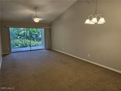 Living/Dining room featuring a chandelier, vaulted