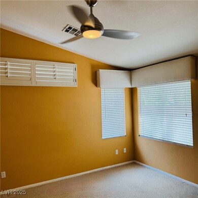 Unfurnished room with ceiling fan, vaulted ceiling