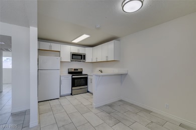 Kitchen with stainless steel appliances, light cou