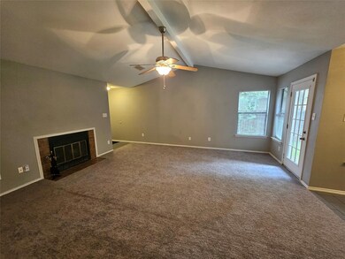 Unfurnished living room featuring a tile fireplac
