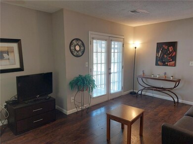Living room with dark wood-style flooring, french 