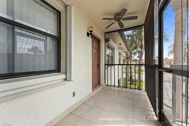 Unfurnished sunroom with a ceiling fan, tile patte