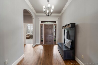 Inviting foyer boasts transom window and high ceil