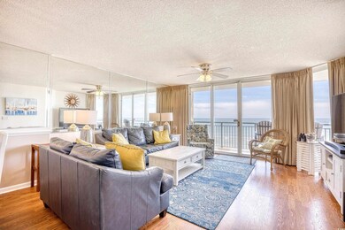 Living room featuring a water view, ceiling fan, h