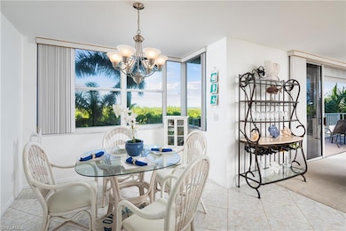 Dining room featuring a chandelier, healthy amount of natural light, and light tile patterned flooring