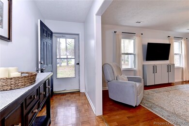 Entryway leading into spacious living room.