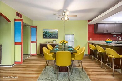 Dining room with ceiling fan and light wood-type flooring