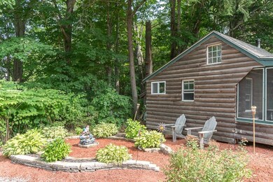 Side of log cabin showing screened...