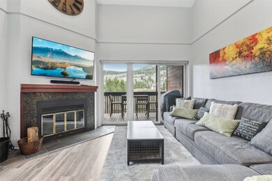 Living area with wood finished floors, a high ceil