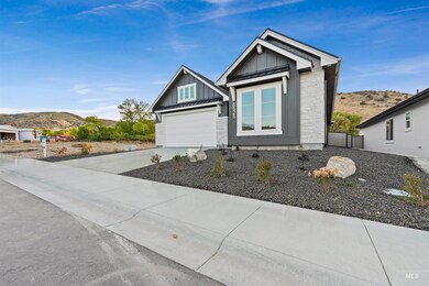 View of front facade with a mountain view, a standing seam roof, concrete driveway, and board and batten siding