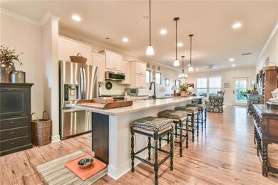 Kitchen with ornamental molding, a spacious island