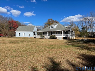 View of front of home with a porch and a front yard