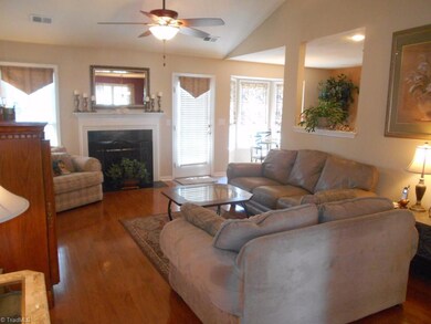 Living room has gas logs and a ceiling fan with 13 Ft. ceilings at the peak