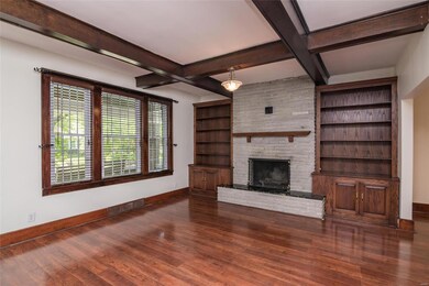 Beamed ceilings, gleaming floors, a fireplace and built-ins in the Living Room.