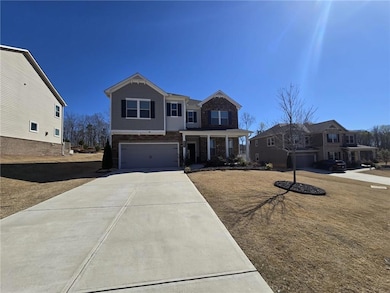 View of front of property with brick siding, a gar