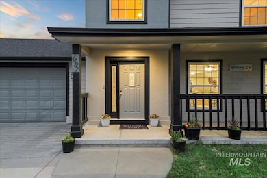 View of exterior entry featuring a porch, stucco siding, and an attached garage