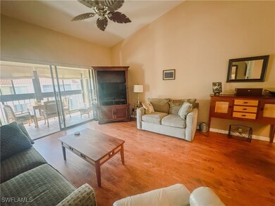Living area featuring a ceiling fan, high vaulted
