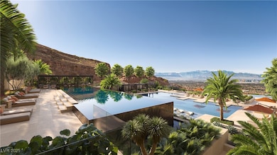 Community pool with a mountain view and a patio ar
