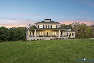 View of front of home with covered porch, a front lawn, and brick siding