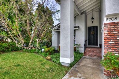Mature and manicured landscaping showcase this hom