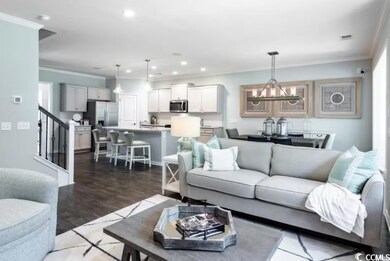 Living area featuring a chandelier, stairway, orna