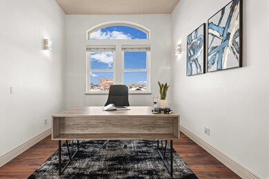 Office area with plenty of natural light and dark wood finished floors