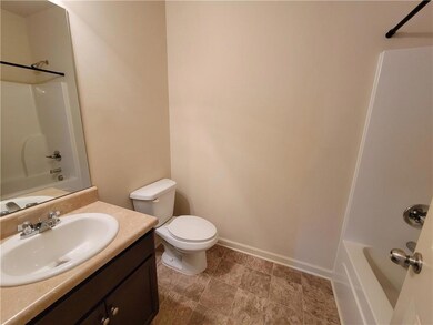Full bathroom featuring baseboards, toilet, vanity