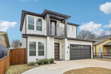 Contemporary house featuring a garage, a balcony &
