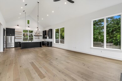 Unfurnished living room featuring a ceiling fan, 